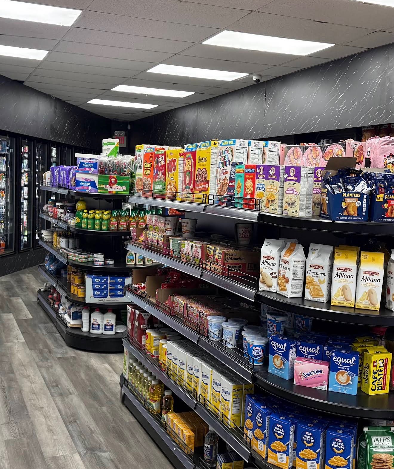 Cold drink coolers and grocery aisle inside Swissland Farm Food Store