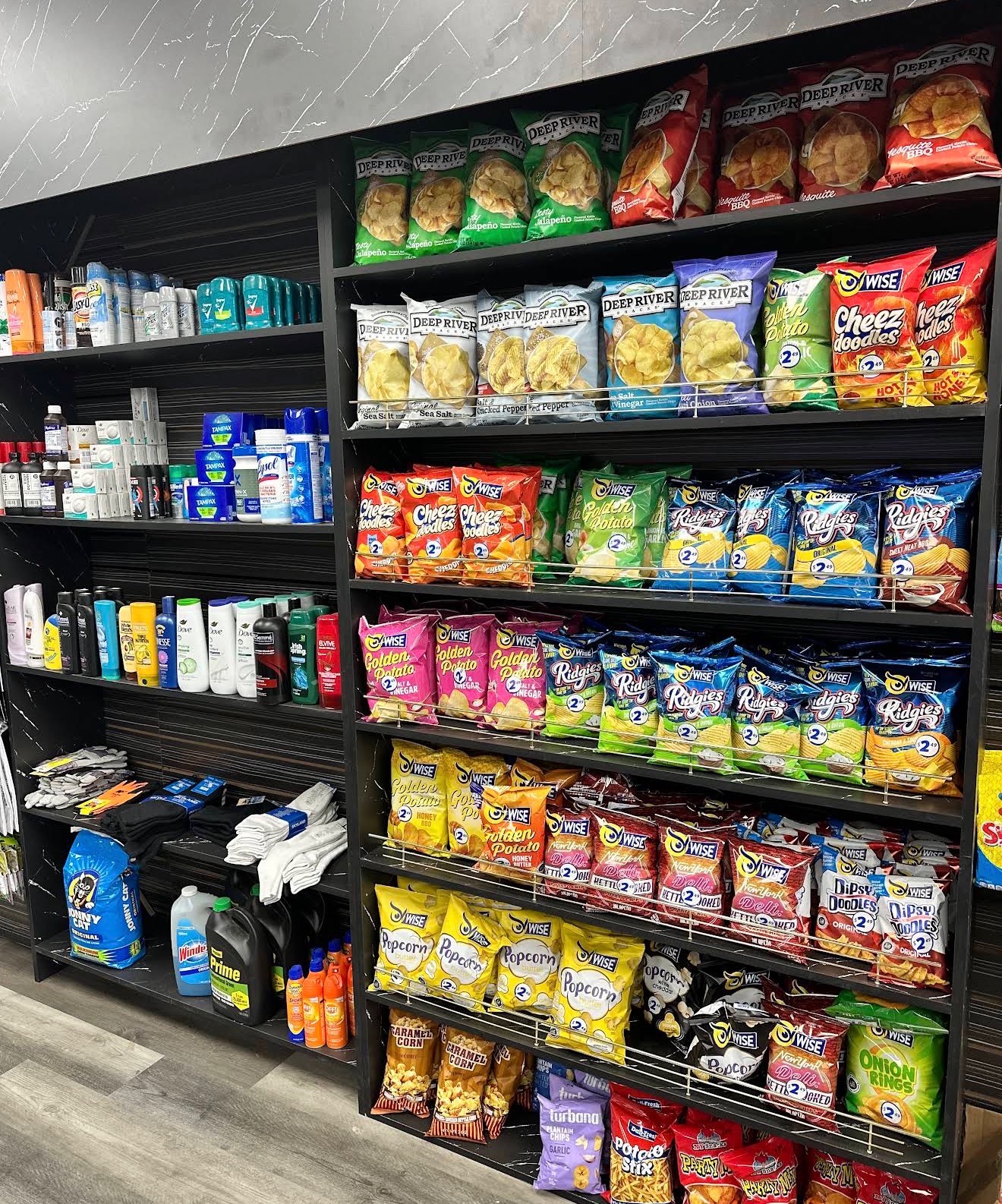Shelves of household and personal care essentials next to chips